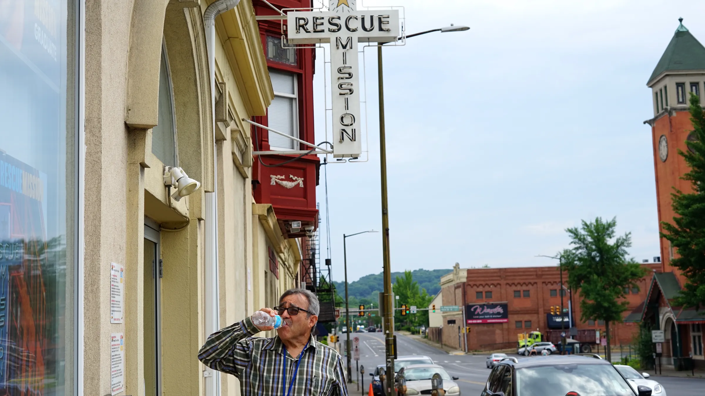 a man drinking water outside of the allentown rescue mission in pennsylvania