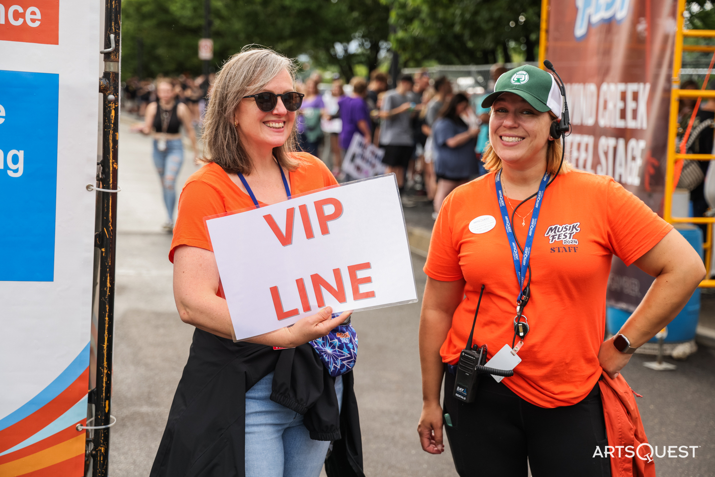 ArtsQuest staff members hold a sign for the VIP line at Musikfest 2024 (Photo Courtesy: Jeff Auger/ArtsQuest)