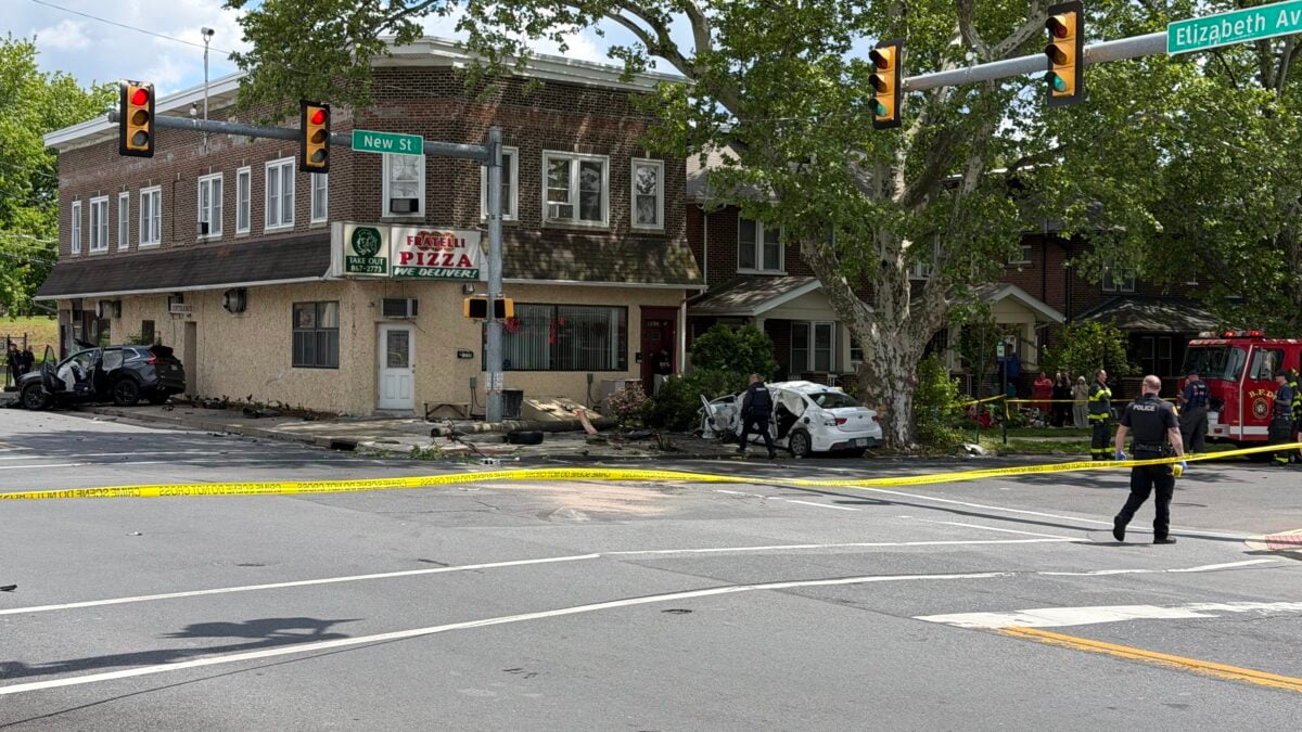 damaged suv against a building and downed wires at a taped-off intersection in bethlehem