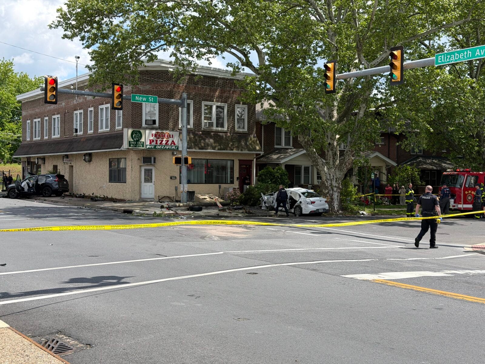 damaged suv against a building and downed wires at a taped-off intersection in bethlehem