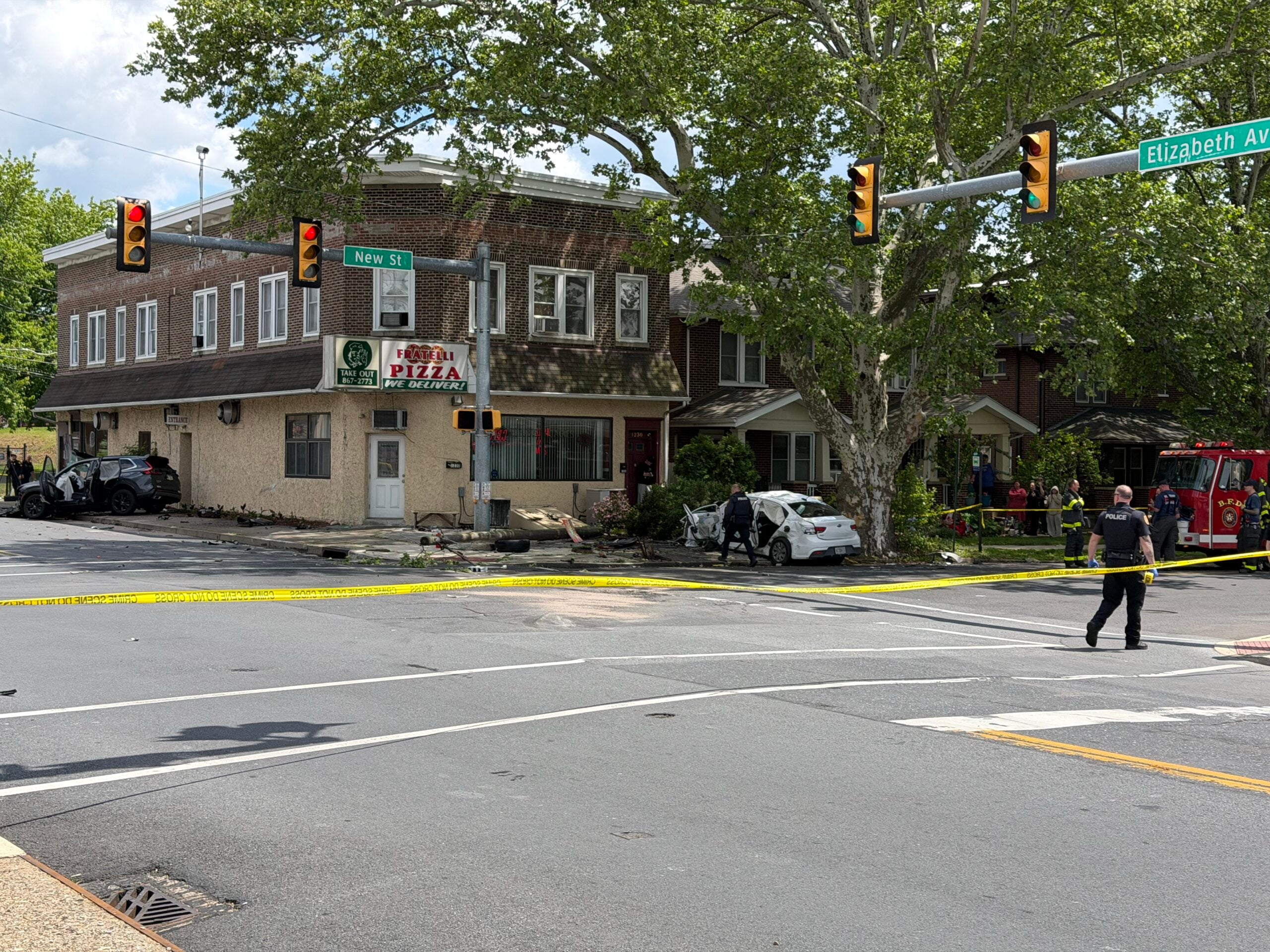 damaged suv against a building and downed wires at a taped-off intersection in bethlehem