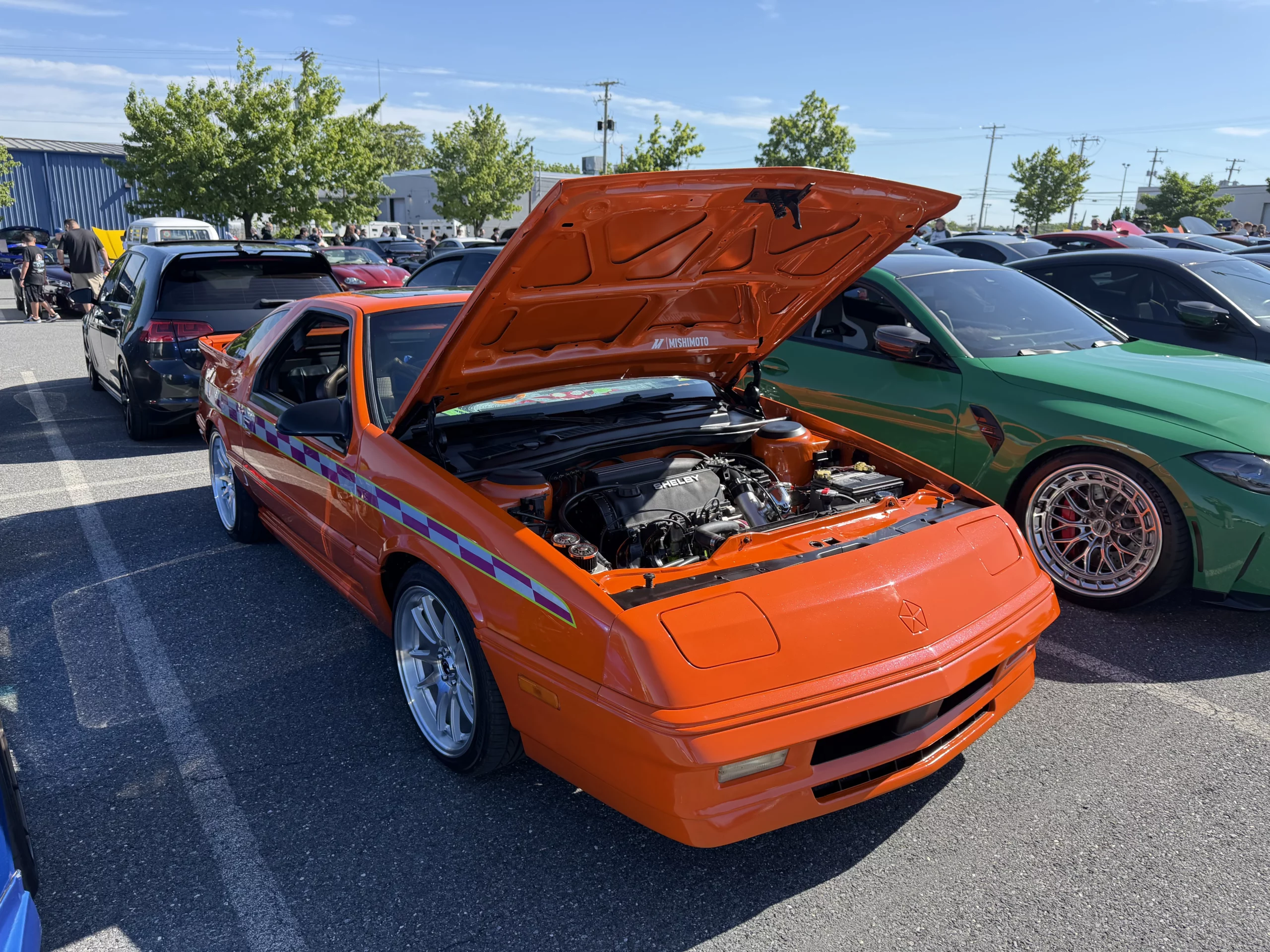 An orange 87' dodge daytona Shelby Z