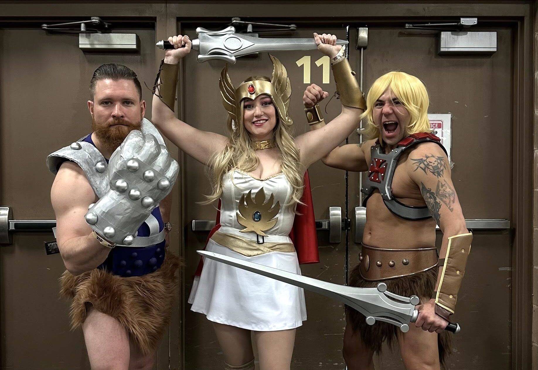 Three cosplayers dressed as “Masters of the Universe” characters pose with prop swords at the Lehigh Valley Comic Convention.