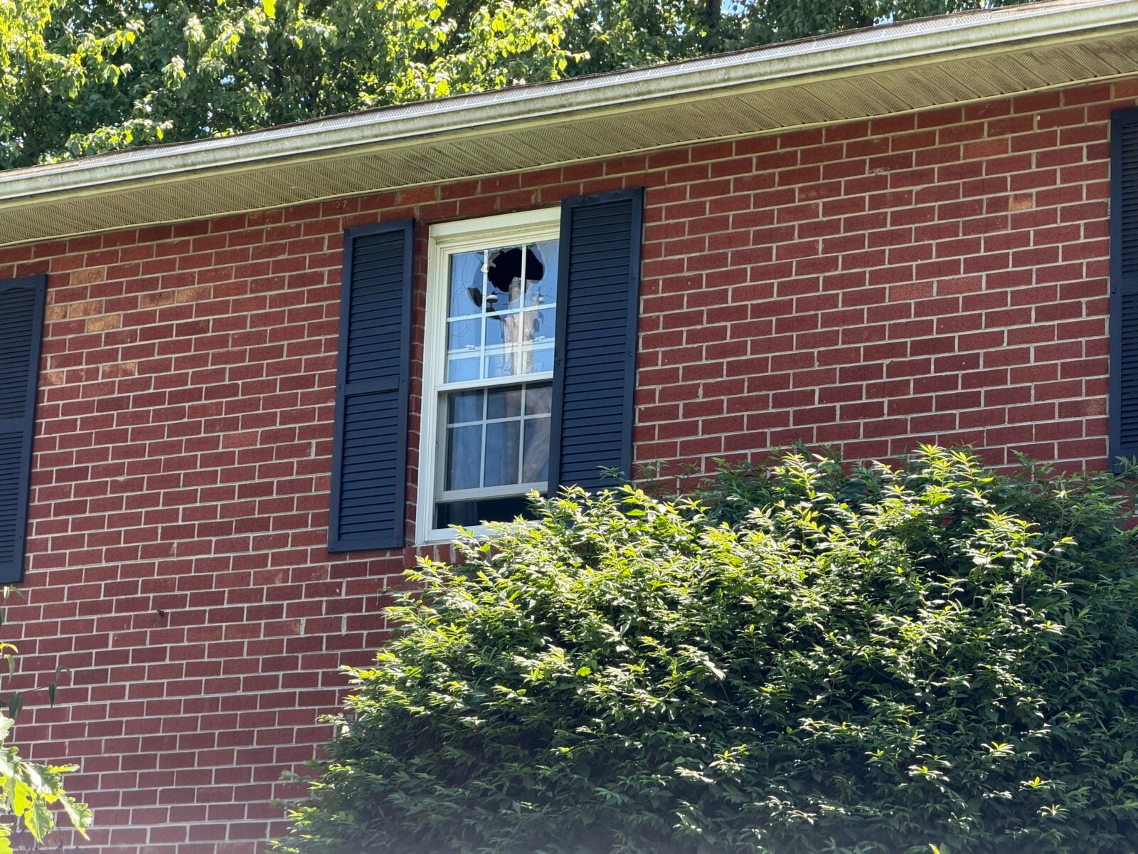 Broken upper window on a red-brick apartment building at Oak Hollow in Bethlehem.