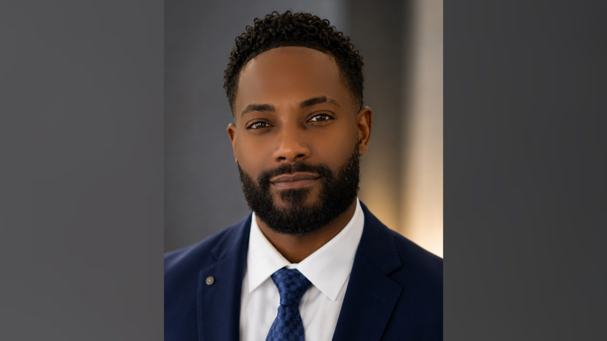 Michael Cooley, who said he plans to run for Bethlehem City Council in 2027, poses for a headshot in a navy suit and blue tie.